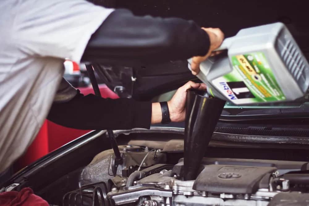Engine oil being added to a vehicle