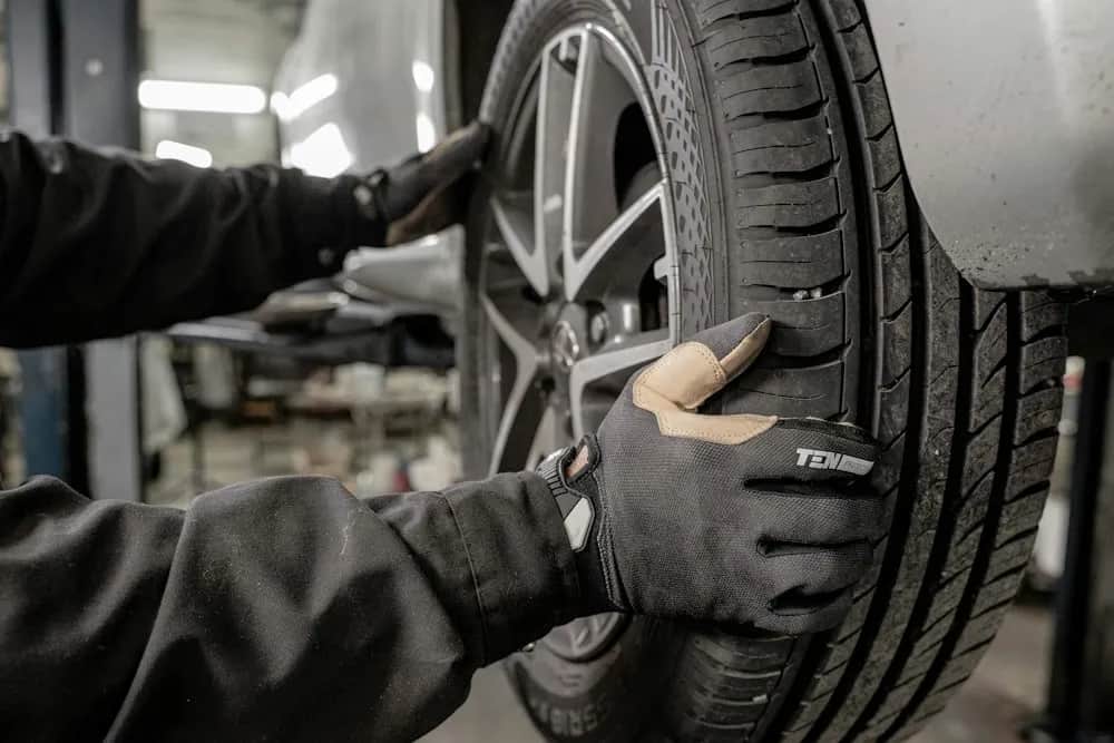 Technician working on a tire in an automotive workshop